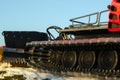 Caterpillar spikes on snowmobile in ski resort. Machine wheels with spikes for winter off road, extreme conditions. Tracked quad