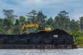 Caterpillar working on a coal barge Royalty Free Stock Photo