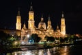 Cathedral basilica of the Pilar of Zaragoza illuminated at night next to the river Ebro, Spain. Royalty Free Stock Photo