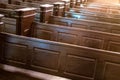 Cathedral benches. Rows of pews in christian church. Heavy solid uncomfortable wooden seats Royalty Free Stock Photo