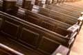 Cathedral benches. Rows of pews in christian church. Heavy solid uncomfortable wooden seats Royalty Free Stock Photo