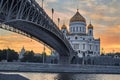 Cathedral Of Christ The Saviour in Moscow in orange sunset light. Patriarch bridge. The bridge leads to the temple. Royalty Free Stock Photo