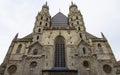 Cathedral church medieval architecture building huge facade front side foreshortening from below on gray cloudy sky background in