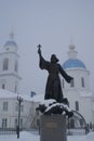 Monument to the regimental priest against the background of the Cathedral of the Kazan Icon of the Mother of God in Maloyaroslavet