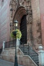 Cathedral of Malaga, Spain. Old stone walls sights, doors and stairs. Black forged street lamp against the background of the Royalty Free Stock Photo