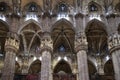 Cathedral of Milan, Duomo Milano, gothic marble colonnade, pillars of the main square, cross vaults and stained glass windows Royalty Free Stock Photo