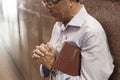 Aparecida, SÃÂ£o Paulo, Brazil - January 13, 2016: Faithful man prays at Cathedral of Nossa Senhora Aparecida