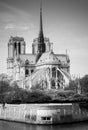 Cathedral of Notre Dame de Paris sunny autumn afternoon. Embankment of the Seine. The natives and tourists take a walk and relax Royalty Free Stock Photo