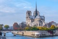 Cathedral of Notre Dame de Paris sunny autumn afternoon. Embankment of the Seine River. The natives and tourists take a walk and Royalty Free Stock Photo