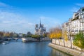 Cathedral of Notre Dame de Paris sunny autumn afternoon. Embankment of the Seine River. The natives and tourists take a walk and Royalty Free Stock Photo