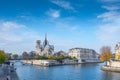 Cathedral of Notre Dame de Paris sunny autumn afternoon. Embankment of the Seine River. The natives and tourists take a walk and Royalty Free Stock Photo