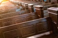 Cathedral pews. Rows of benches in christian church. Heavy solid uncomfortable wooden seats Royalty Free Stock Photo