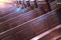 Cathedral pews. Rows of benches in christian church. Heavy solid uncomfortable wooden seats Royalty Free Stock Photo