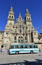 Cathedral with pilgrims taking pictures at Plaza del Obradoiro with old bus from exhibition. Santiago de Compostela, Spain.