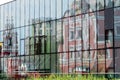 Cathedral reflection in wall of modern building