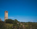 Cathedral of Santa Maria Assunta`s bell tower under blue sky on island of Torcello, Venice, Italy Royalty Free Stock Photo