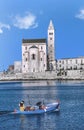 Cathedral on the sea in Trani with a fisherboat passing