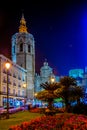 cathedral in spanish city valencia behind a small park situated on the plaza de la reina square during night...IMAGE Royalty Free Stock Photo