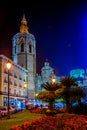 cathedral in spanish city valencia behind a small park situated on the plaza de la reina square during night...IMAGE Royalty Free Stock Photo