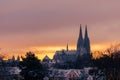 The cathedral St. Peter in Regensburg on cold winter morning in December with fresh snow on the roofs and spires