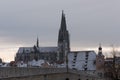 The cathedral St. Peter in Regensburg on cold winter morning in December with fresh snow on the roofs and spires