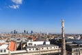 Cathedral statue and view of Milan cityscape