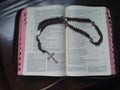 Catholic bible on the table with a prayer rosary