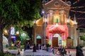 Catholic church cathedral at night. People praying, mass celebration outside the building. Neon lights. Concrete benches. Scooters Royalty Free Stock Photo