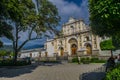 Catholic church with classical architecture with park and people walking