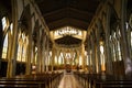 Catholic church interior with empty benches, columns and Jesus Christ Royalty Free Stock Photo