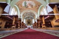 Catholic church interior with pews, statues and altar Royalty Free Stock Photo