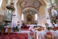 Catholic church interior with pews, statues and altar Royalty Free Stock Photo