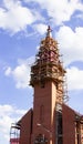 Catholic church during the restoration of the building. surrounded by scaffolding against the blue sky. Vertical orientation Royalty Free Stock Photo