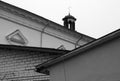 Catholic church roof top with cross behind residential buildings Royalty Free Stock Photo