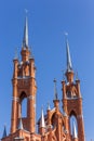 Catholic Church of the Sacred Heart of Jesus in Samara. High Gothic towers on a background of blue sky