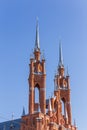 Catholic Church of the Sacred Heart of Jesus in Samara. High Gothic towers on a background of blue sky