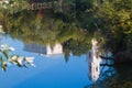 Catholic church Sanctuary of Jesus of Nazareth, is reflected in still water surface of river Riv, Brailiv, Ukraine