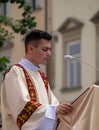 Catholic clergyman at the Corpus Christi procession taking place in the streets of Krakow old town, Poland