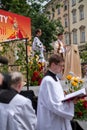 Catholic clergyman at the Corpus Christi procession taking place in the streets of Krakow old town, Poland