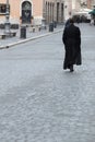 Priest in clerical collar walking