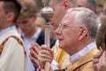 Catholic clergyman at the Corpus Christi procession taking place in the streets of Krakow old town, Poland