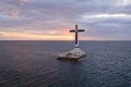 Catholic cross in a flooded cemetery in the sea near the island of Camiguin. Royalty Free Stock Photo