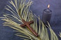 Catholic Cross with palm leaf and burning candle. Ash Wednesday, Lent season, Holy Week, Good Friday and Palm Sunday concept. Royalty Free Stock Photo