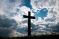 Catholic cross silhouette at sundown, dramatic storm clouds Royalty Free Stock Photo