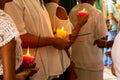 Catholic faithful holding lit candles inside the Campo Santo church in the city of Salvador, Bahia Royalty Free Stock Photo