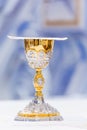 Catholic Holy Mass - covered golden chalice with wine on the altar