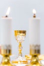 Catholic Holy Mass - golden chalice with wine on the altar