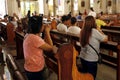 Catholic men and women kneel down and pray inside the Antipolo Cathedral or the Our Lady of Peace and Good Voyage church Royalty Free Stock Photo