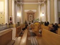 Catholic men and women kneel and pray inside the Cathedral