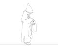 Catholic monk in a cassock with a hood holds an old lamp